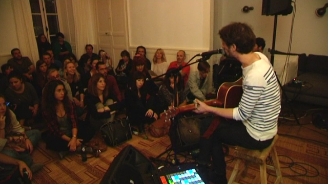 Un musicien et ses spectateurs dans un appartement du centre de Rennes.